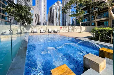 a swimming pool in a city with buildings at Vogue Downtown The Lofts near Burj Khalifa and Dubai Mall, Two Bedroom Apartment with Balcony and City Skyline View, Access to all Amenities in Dubai