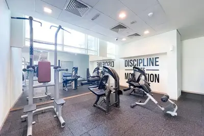 a gym with treadmills and machines in a room at Vogue Downtown The Lofts near Burj Khalifa and Dubai Mall, Two Bedroom Apartment with Balcony and City Skyline View, Access to all Amenities in Dubai