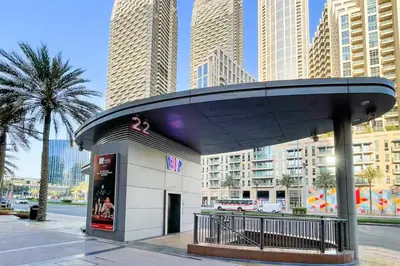 a building with a curved roof in a city at Vogue Downtown The Lofts near Burj Khalifa and Dubai Mall, Two Bedroom Apartment with Balcony and City Skyline View, Access to all Amenities in Dubai