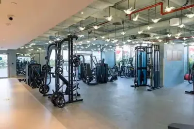 a gym with a lot of treadmills and machines at Vogue Downtown Mag 318 near Burj Khalifa and Dubai Mall, Studio Apartment with Balcony, Canal and City View, Access to all Amenities in Dubai