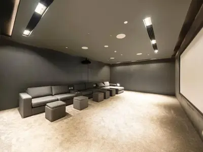 a living room with couches and a projection screen at New Luxury 2 Bedroom with Padel Gym Pool Cinema BBQ in Dubai