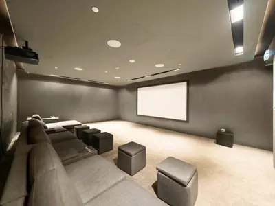a theater room with a couch and a screen at New Luxury 2 Bedroom with Padel Gym Pool Cinema BBQ in Dubai