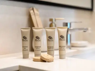 a group of four tubes of sunscreen sitting on a bathroom counter at Mahogany 16 - 1BR 4 Guests - Walk to Burj Khalifa in Dubai