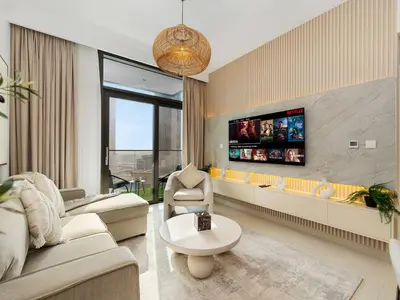 a living room with a couch and a tv at Mahogany 16 - 1BR 4 Guests - Walk to Burj Khalifa in Dubai