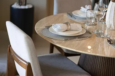 a wooden table with plates and napkins on it at Mahogany 15 - 1BR 4 Guests - Walk to Burj Khalifa in Dubai