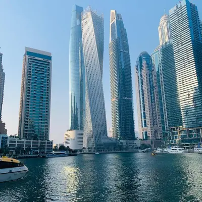 a group of tall buildings in a city with a river at Modern Studio in Marina in Dubai