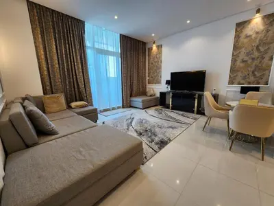 a large living room with a couch and a desk at Modern Monastery 1 BR Business Bay in Dubai