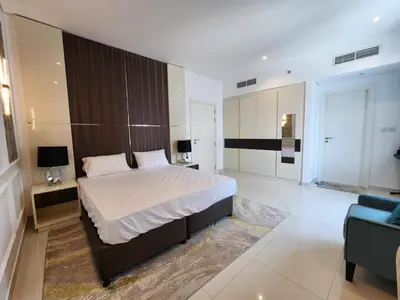 a bedroom with a large bed and a couch at Modern Monastery 1 BR Business Bay in Dubai