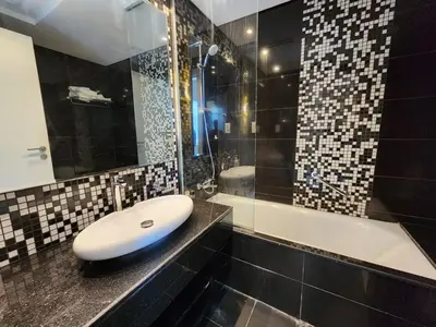 a bathroom with a sink and a bath tub at Modern Monastery 1 BR Business Bay in Dubai