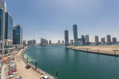 a body of water in a city with tall buildings at Modern Monastery 1 BR Business Bay in Dubai