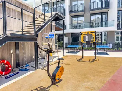 a gym in a building with a gym equipment at Modern Studio - Pool, Gym & Padel in Dubai