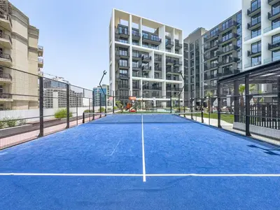 a tennis court in the middle of a building at Modern Studio - Pool, Gym & Padel in Dubai