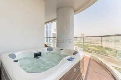 a hot tub in a building with a large window at Spacious Balcony with Private Jacuzzi and Stunning Views, Easy Public Transport Access, Terraces Marasi Drive, Business Bay by Deluxe Holiday Homes in Dubai