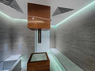 a room with a table and a cabinet in it at Spacious Balcony with Private Jacuzzi and Stunning Views, Easy Public Transport Access, Terraces Marasi Drive, Business Bay by Deluxe Holiday Homes in Dubai