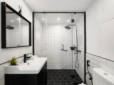 a white bathroom with a shower and a sink at 4 BHK Duplex - Marina & JBR - Iconic Dubai Skyline in Dubai