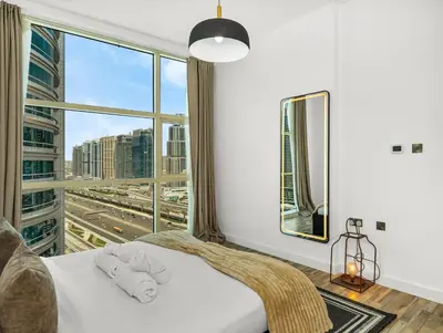 a bedroom with a white bed with a large window at 4 BHK Duplex - Marina & JBR - Iconic Dubai Skyline in Dubai