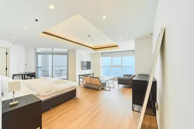 a bedroom with a bed and a living room at Exclusive Torch Tower Penthouse In Dubai Marina in Dubai