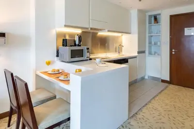 a kitchen with a counter top and a microwave at Luxury Studio Burj Khalifa View Address Dubai Mall in Dubai
