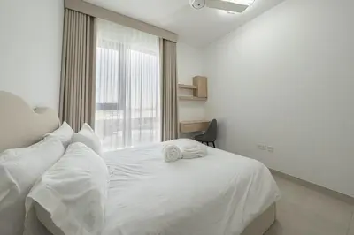 a white bed in a room with a window at Luxury Villa 3BR with garden in Dubai