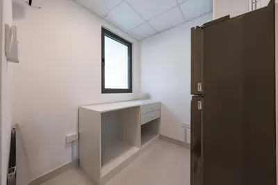 a white room with a desk and a window at Luxury Villa 3BR with garden in Dubai