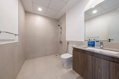a bathroom with a toilet and a sink and a mirror at Luxury Villa 3BR with garden in Dubai