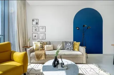 a living room with a couch and a table at 1 Bedroom lagoon by District One in Dubai