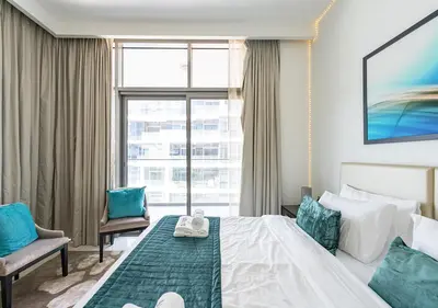 a hotel room with a bed and a large window at Chic 2BR in Damac Hills with Golf & Pool View in Dubai