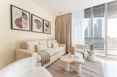 a living room with a white couch and a large window at Iconic Views of the Future Museum, Minutes from Metro & Key Attractions, Sky Gardens, DIFC by Deluxe Holiday Homes in Dubai