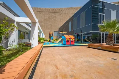 a playground in the courtyard of a building at Iconic Views of the Future Museum, Minutes from Metro & Key Attractions, Sky Gardens, DIFC by Deluxe Holiday Homes in Dubai