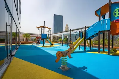 an empty playground with a slide at Iconic Views of the Future Museum, Minutes from Metro & Key Attractions, Sky Gardens, DIFC by Deluxe Holiday Homes in Dubai