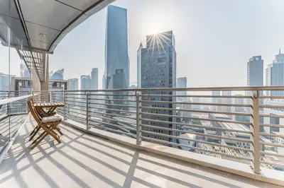 a balcony with a chair and a view of the city at Iconic Views of the Future Museum, Minutes from Metro & Key Attractions, Sky Gardens, DIFC by Deluxe Holiday Homes in Dubai