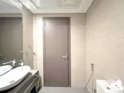 a bathroom with a shower and a sink and a door at Gorgeous Studio with balcony l Business Bay in Dubai