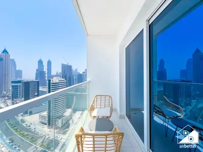 a balcony with a chair and a view of the city at Gorgeous Studio with balcony l Business Bay in Dubai