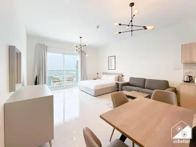 a living room with a couch and a table at City-View Studio in AG Tower l Pool & Gym Access in Dubai