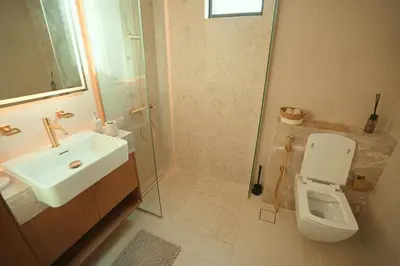 a bathroom with a sink and a toilet and a shower at Private Jacuzzi 2BR Luxury Unit in Dubai
