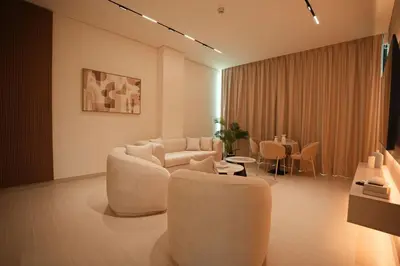 a living room with two couches and a table at Private Jacuzzi 2BR Luxury Unit in Dubai