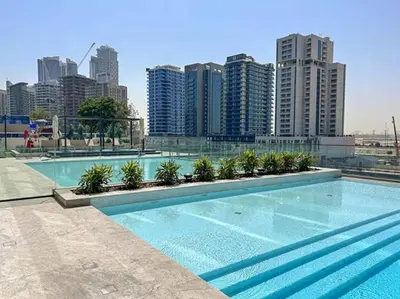 a large swimming pool with a city in the background at Private Jacuzzi 2BR Luxury Unit in Dubai