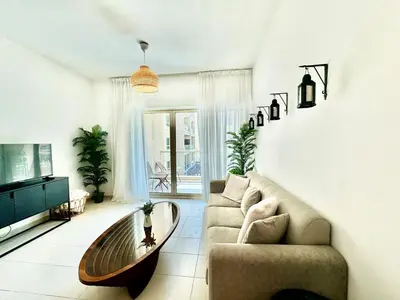 a living room with a couch and a coffee table at The Greens very well-lit unit in Dubai