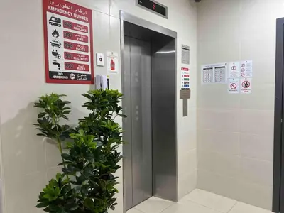 a elevator in a building with a plant next to it at 1 min to ADCB metro New home in Dubai