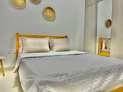 a bedroom with a large bed with white sheets and pillows at 1 min to ADCB metro New home in Dubai