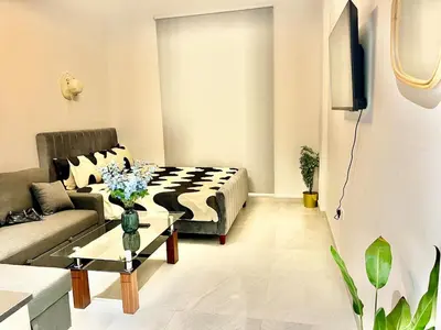 a living room with a couch and a table at 3 mins walk to ADCB metro in Dubai