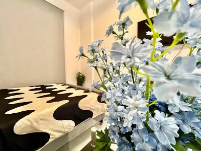 a room with a bed with blue and white flowers at 3 mins walk to ADCB metro in Dubai