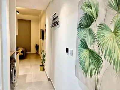 a hallway with a mural of palm trees on the wall at 3 mins walk to ADCB metro in Dubai
