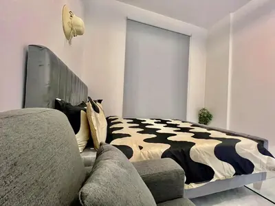 a bedroom with a bed and a couch at 3 mins walk to ADCB metro in Dubai