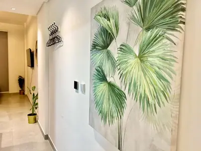 a mural of palm trees on a wall in a hallway at 3 mins walk to ADCB metro in Dubai