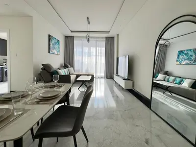a living room with a dining table and a couch at Modern 1BR with Private Jacuzzi in Business Bay in Dubai