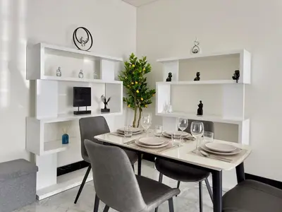 a dining room with a table with chairs and a christmas tree at Modern 1BR with Private Jacuzzi in Business Bay in Dubai