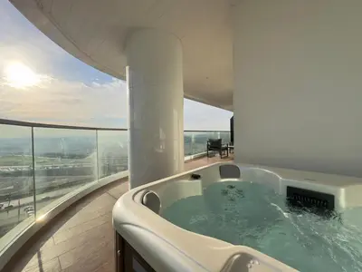 a bath tub in the middle of a room with a view at Modern 1BR with Private Jacuzzi in Business Bay in Dubai