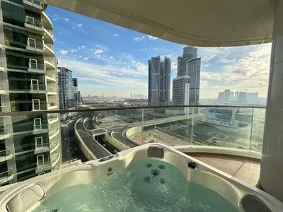 a bath tub in a building with a view of a city at Modern 1BR with Private Jacuzzi in Business Bay in Dubai