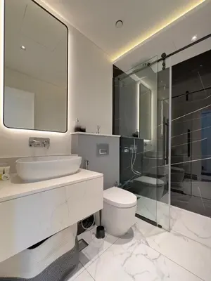 a bathroom with a sink and a toilet and a shower at Modern 1BR with Private Jacuzzi in Business Bay in Dubai